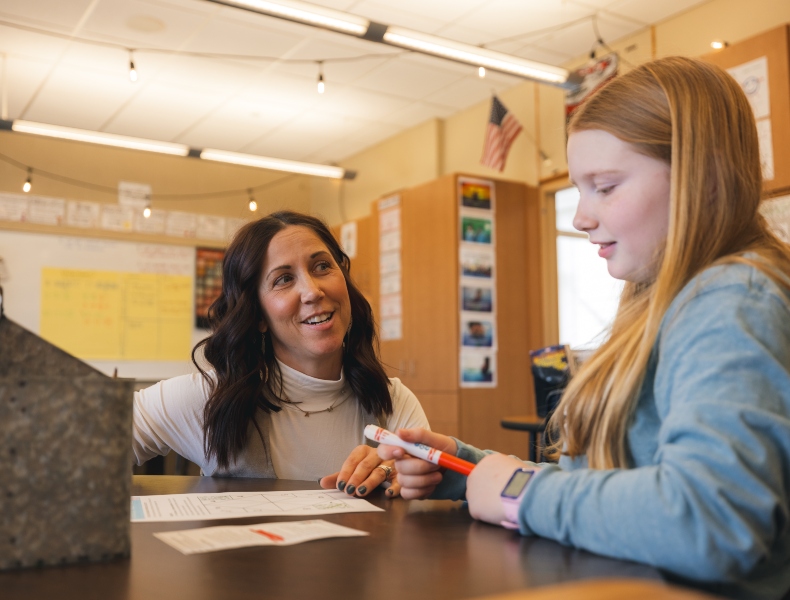 Teacher working with a student.