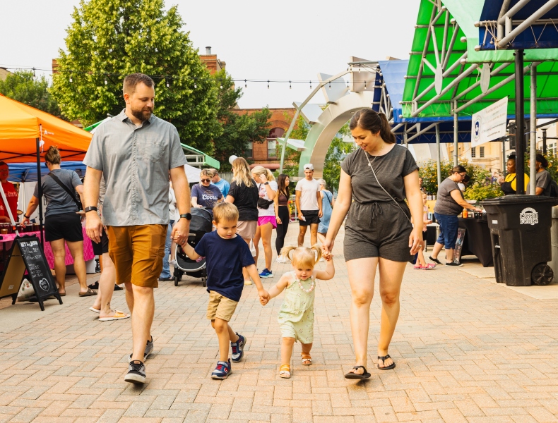 Family holding hands walking.
