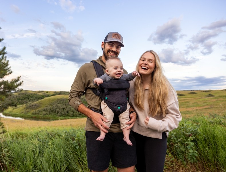 Young family outdoors hiking.