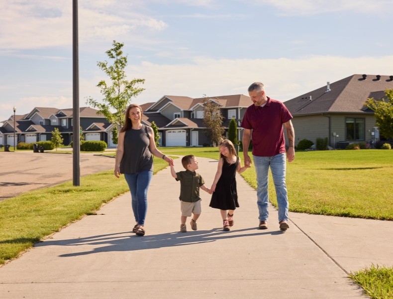 Young family walking on the sidewalk.